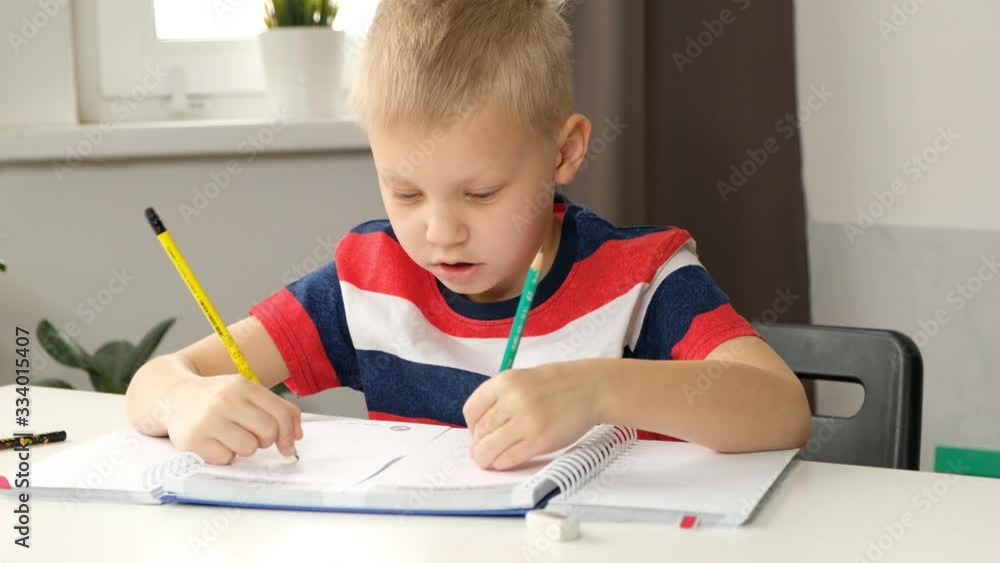 Child boy toddler drawing with two hands, close up. Creativity concept, stay at home, kids education Child boy toddler drawing with two hands, close up. Creativity concept, stay at home, kids education