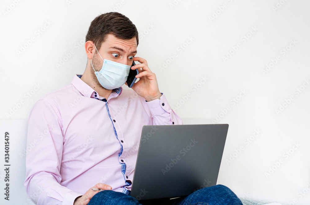 Coronavirus. Quarantine. A man in a shirt and jeans solves work issues remotely. Coronavirus. Quarantine. A man in a shirt and jeans solves work issues remotely.