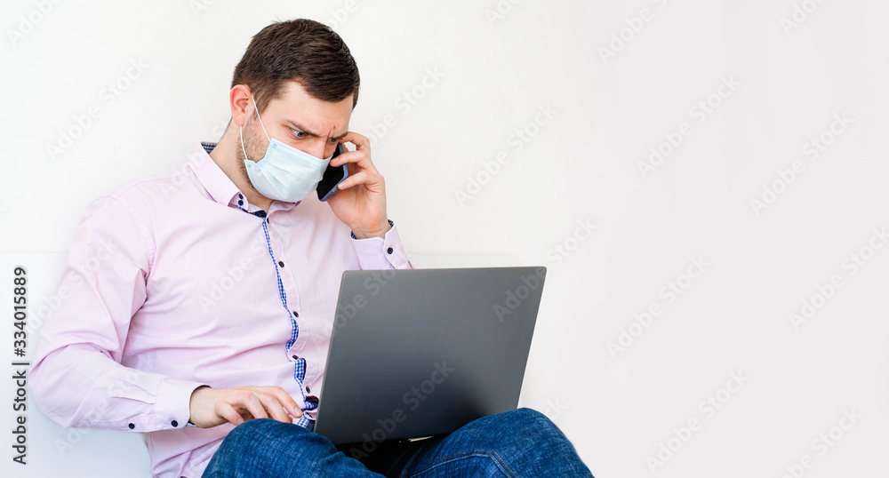 Coronavirus. Quarantine. A man in a shirt and jeans solves work issues remotely. Coronavirus. Quarantine. A man in a shirt and jeans solves work issues remotely.