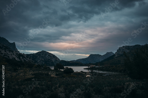 mountain lake in moody atmosphere after sunset