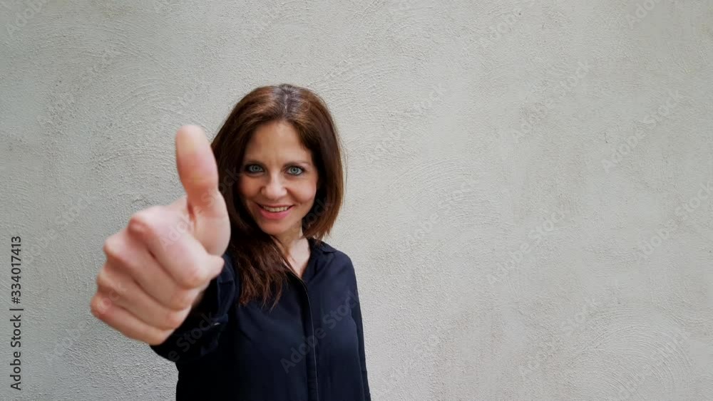 COVID-19 Beautiful woman takes off coronavirus medical mask and giving thumb up