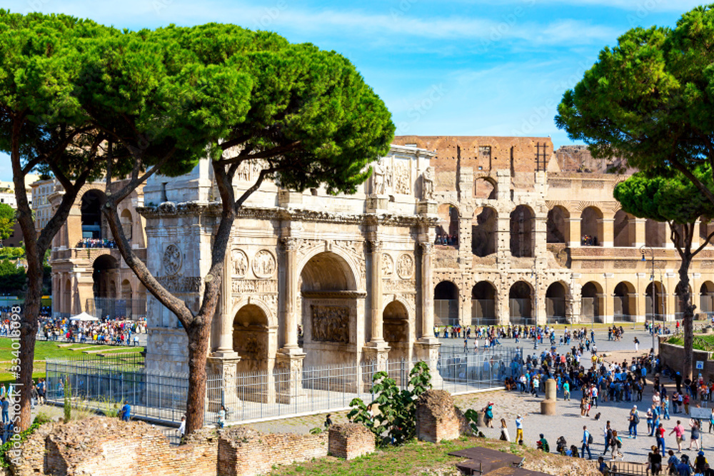 Obraz premium The Colosseum and Arch of Constantine in Rome, Italy during summer sunny day. The world famous colosseum landmark in Rome.