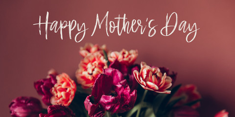 Happy Mothers day quote. Beautiful Bunch of Peony Style Tulips in the Vase on the dusty pink background, spring holiday concept, banner size
