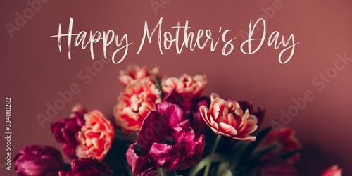 Happy Mothers day quote. Beautiful Bunch of Peony Style Tulips in the Vase on the dusty pink background, spring holiday concept, banner size