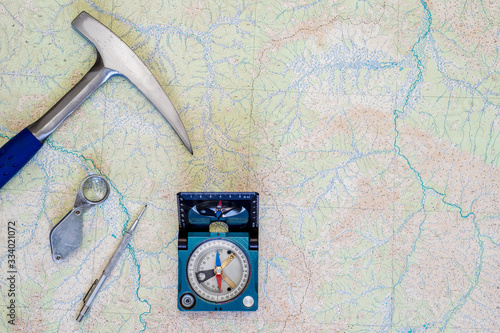 Fotografie The tools of the geologist laid out on a topographic map