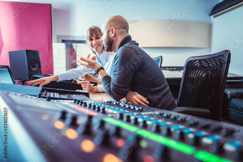 Quadro em tela Sound engineer and singer or musician discussing the mix