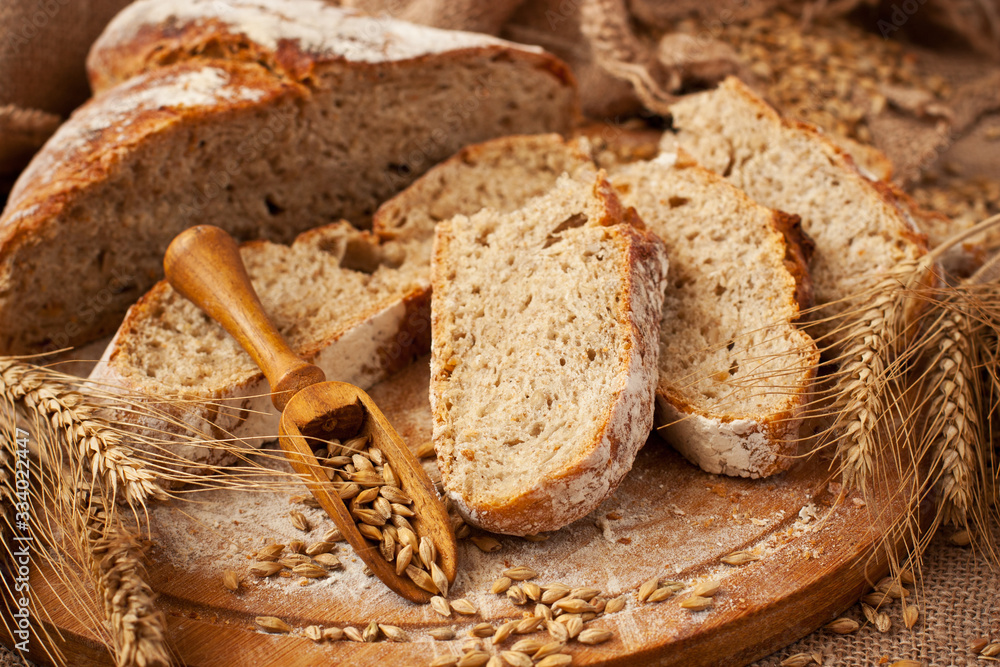 Fresh wheat and rye loaf of bread, rustic style