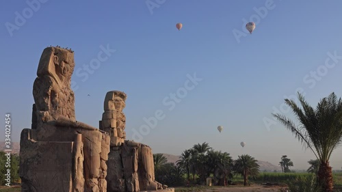Colossi of Memnon gigantic statues and air balloons in Luxor Egypt, 4k
