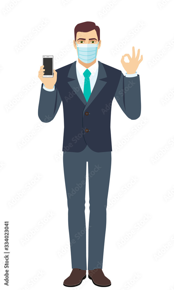 Businessman with medical mask holding mobile phone and show a okay hand sign. Full length portrait of Businessman in a flat style. Businessman with medical mask holding mobile phone and show a okay hand sign. Full length portrait of Businessman in a flat style.