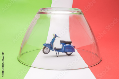 Covid-19 italy abstract made of scooter model under glass cover isolation on italian flag.