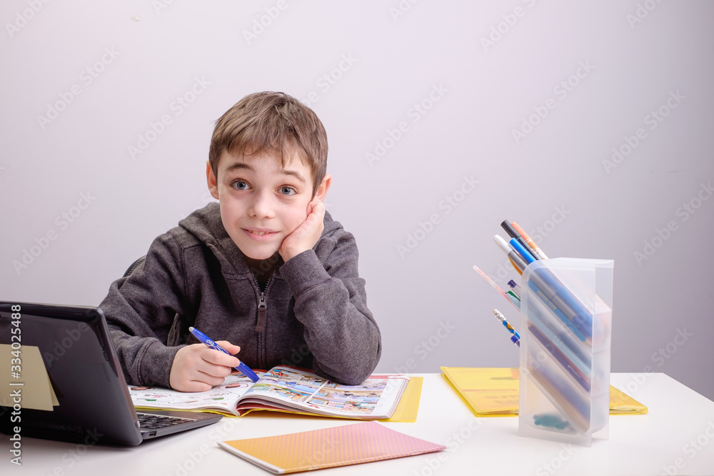 schoolboy studying homework math during his online lesson at home, social distance during quarantine, self-isolation, online education concept, home schooler, playing chess schoolboy studying homework math during his online lesson at home, social distance during quarantine, self-isolation, online education concept, home schooler, playing chess