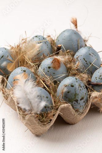 Easter eggs on white background. Blue eggs with feather