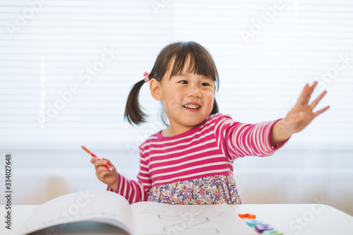 toddler girl practice writing letters for homeschooling