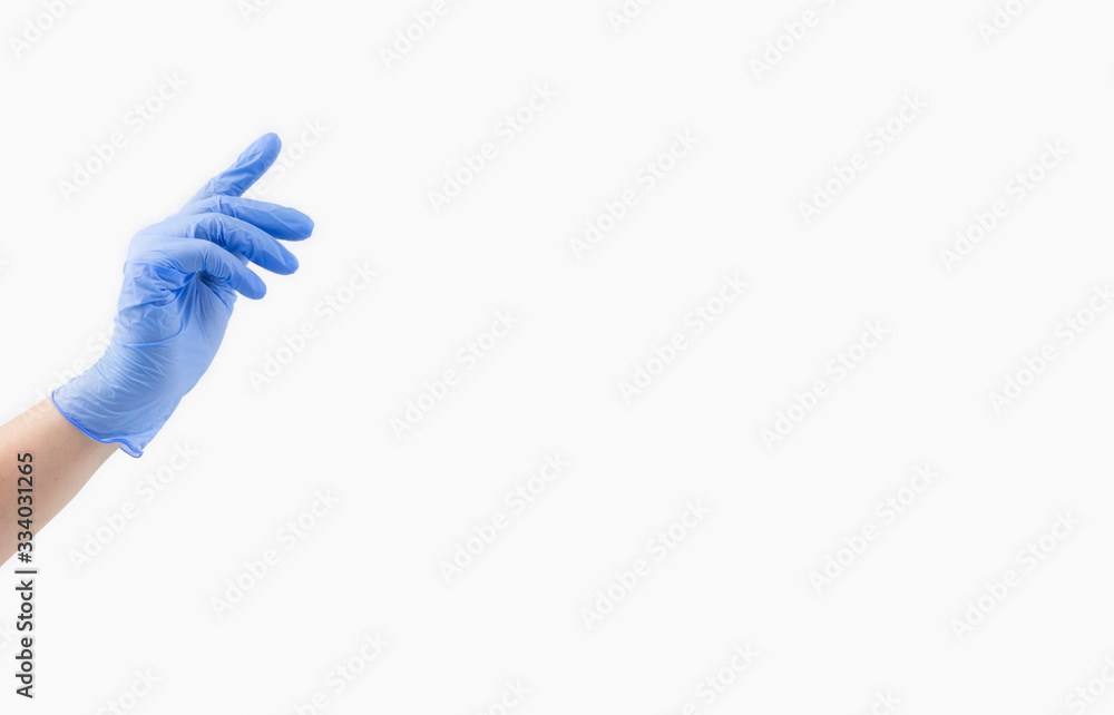 One hand of a woman doctor in a blue sterile medical glove on a white background, banner. With your index finger, reach for the top. copy space.