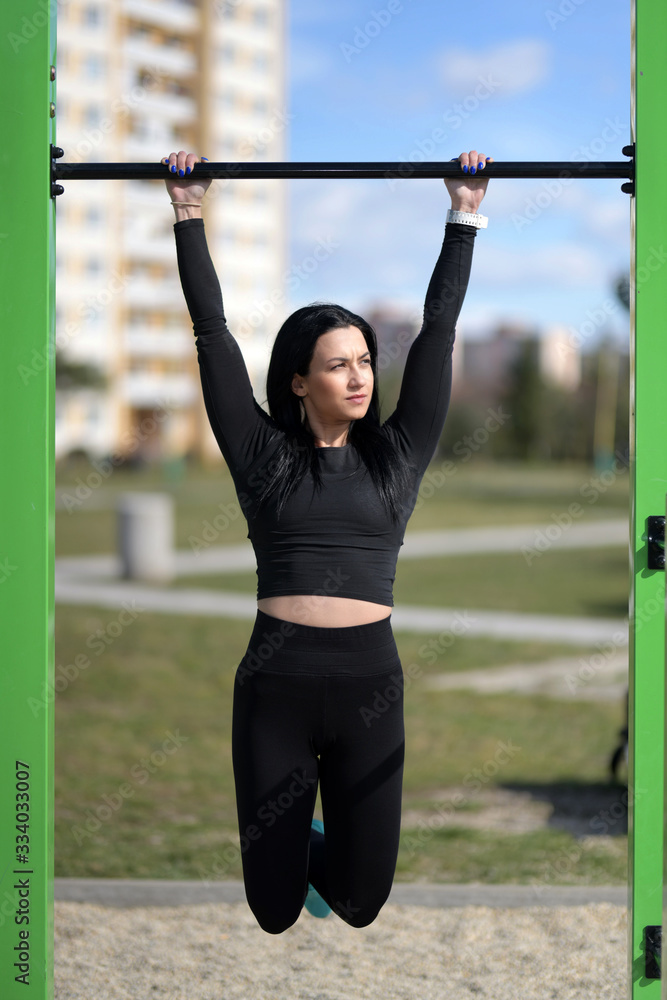 Beautiful sport fitness girl in sportswear doing fitness exercise. Outdoor sports.