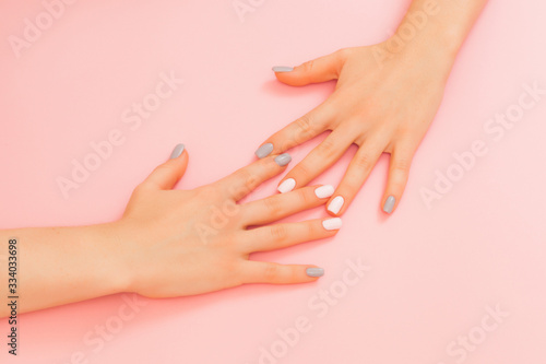 Beautiful woman manicure on creative trendy pink background. Minimalist manicure trend. Top view  flat lay. Copy space for your text.