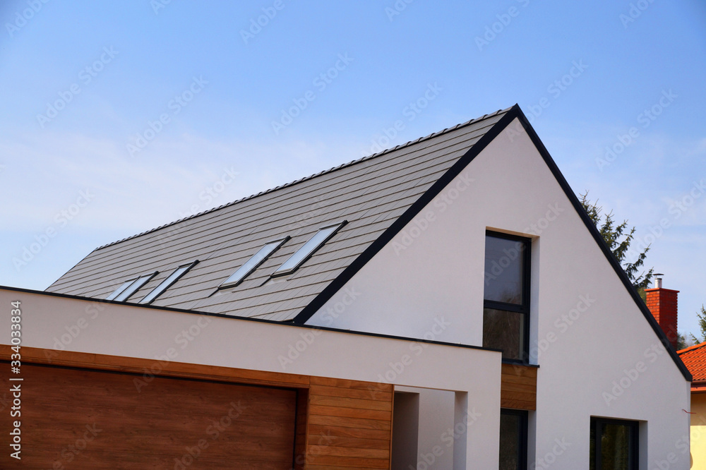 A newly built house. The roof is made of ceramic tiles. - obrazy, fototapety, plakaty 