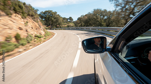 Fotografie rental car in spain mountain landscape road at sunset