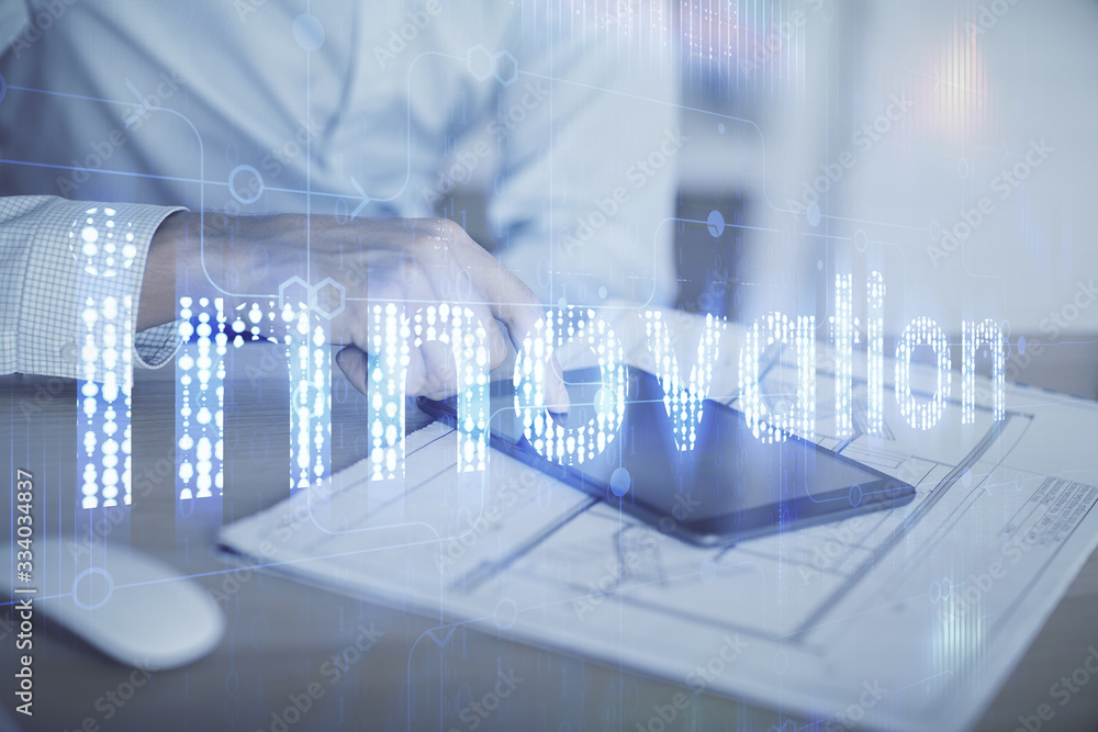 Double exposure of man's hand holding and using a digital device and data theme hologram drawing. Technology concept. Double exposure of man's hand holding and using a digital device and data theme hologram drawing. Technology concept.