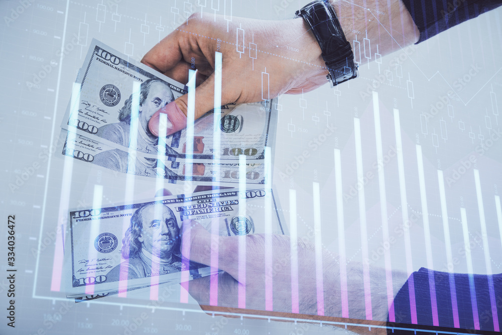 Multi exposure of financial graph drawing hologram and USA dollars bills and man hands. Analysis concept.