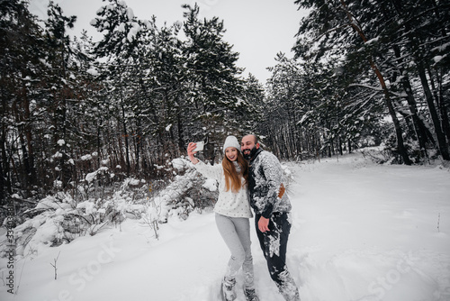 Couple playing with snow in the forest © Andrii