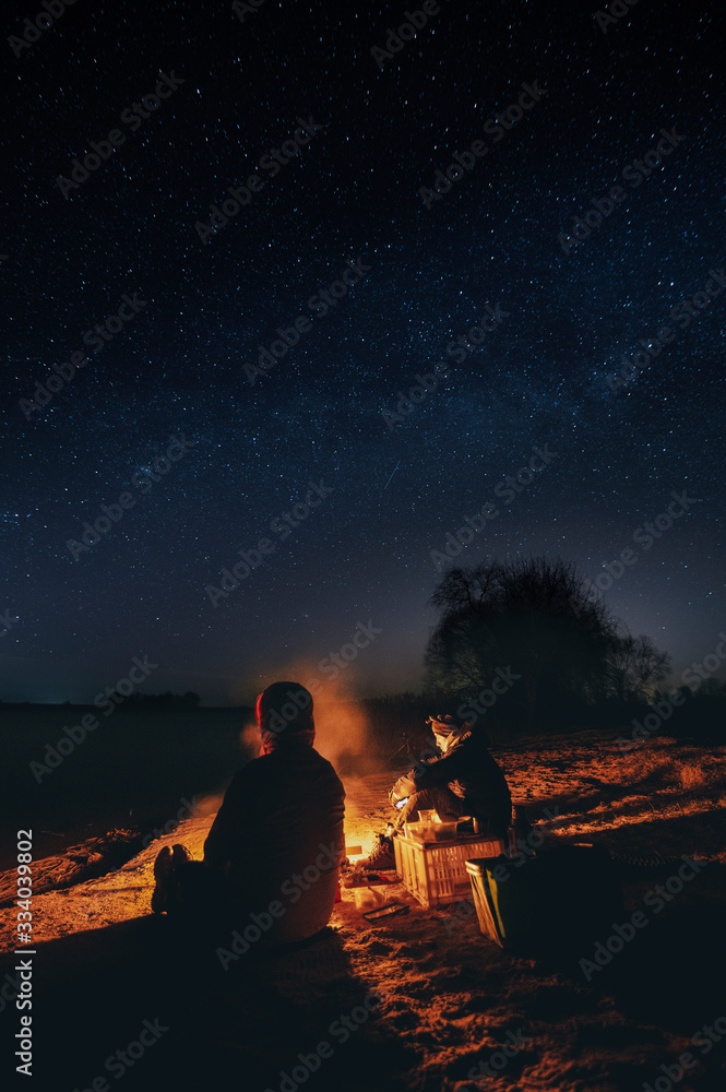 Campfire at night with a sky full of stars in background (high ISO image)