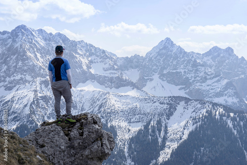 Junger Mann beim Bergsteigen in den Alpen. Mit Imposanten Bergmassiven im Hintergrund