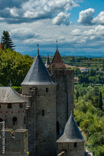 Picturesque walls of medieval  castle with metal roofs observing towers.