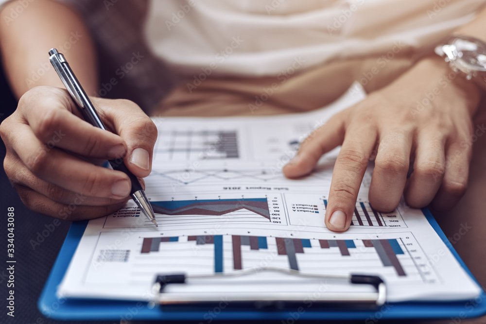 Businessman hold pen and working calculate data. document graph chart and report marketing. Business office concept. Businessman hold pen and working calculate data. document graph chart and report marketing. Business office concept.