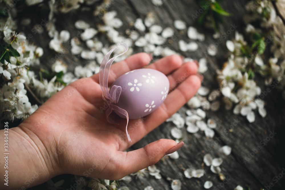 Egg on wooden background in human hands. Easter. Eggs. Bunny. Painted eggs. Holy day. People. Religion. Egg on wooden background in human hands. Easter. Eggs. Bunny. Painted eggs. Holy day. People. Religion.