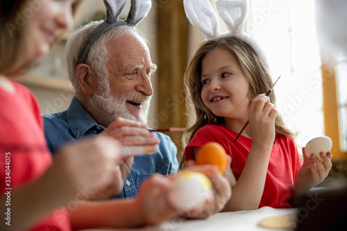 Wall Mural Delighted aged man laughing with granddaughters stock photo