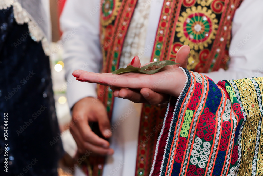 Muslim henna ceremony ritual items and hands close up