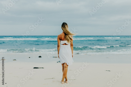 Wallpaper Mural woman walking on the beach Torontodigital.ca