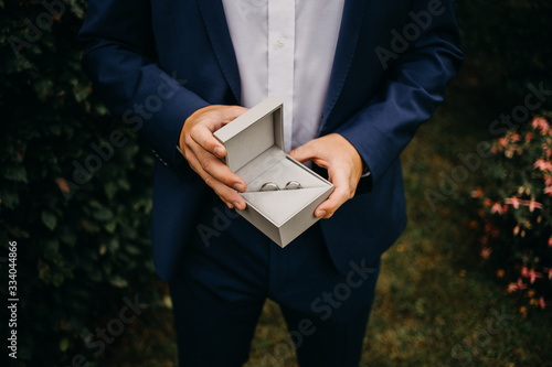 Wallpaper Mural young man holding wedding rings Torontodigital.ca