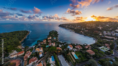 France, Saint-Jean-Cape-Ferrat, 15 December 2019: Aerial view of most expensive place in French Riviera at sunset, terraces of country houses and estates, pools, Chaise lounges, pink clouds