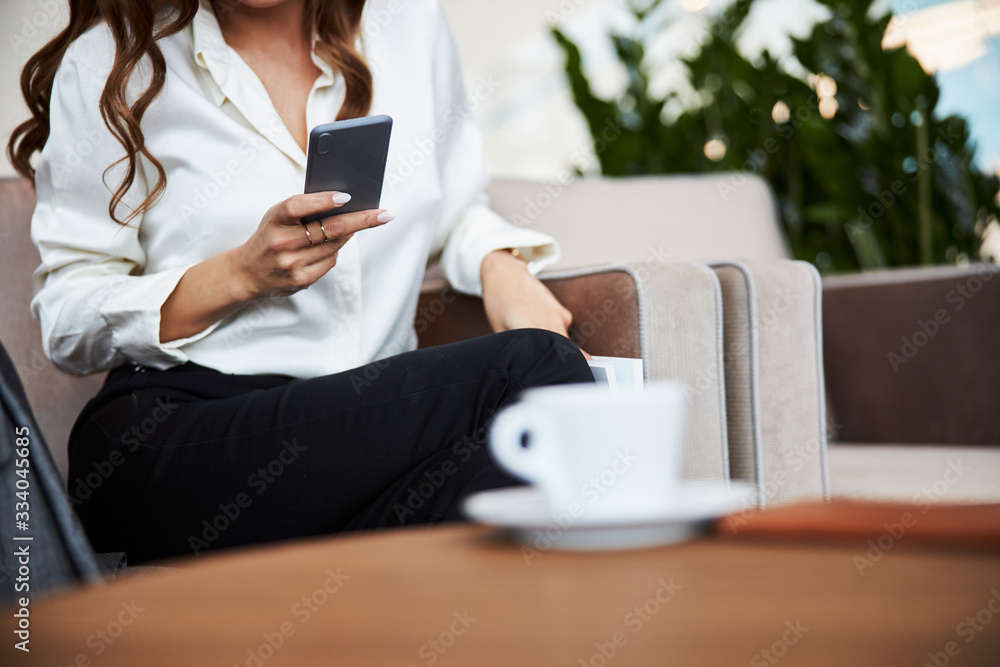 Stylish young woman in white shirt using cellphone Stylish young woman in white shirt using cellphone