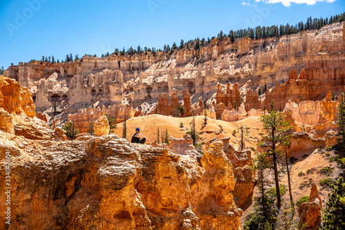 Woman hiking through the stunning Bryce Canyon in Utah, United States. Taken in the beautiful, warm summer. 