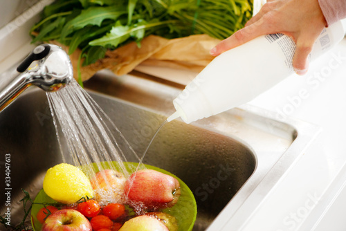 Washing fruit adding sterilizing liquid photo