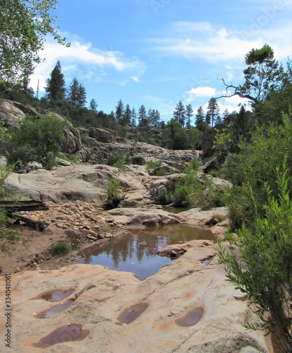 View on the Water Wheel Falls hiking trail located in Payson, Arizona with blue sky and clouds in the background 