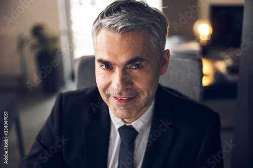 Mature office worker in suit looking at camera