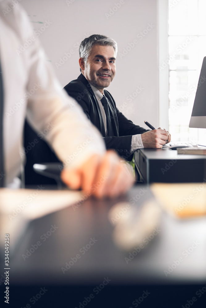 Handsome mature office worker smiling in office Handsome mature office worker smiling in office