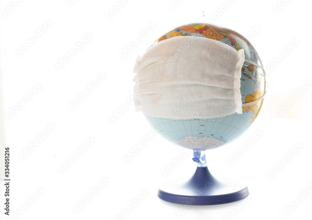 the globe layout in medical mask, a virus across the land,searching for vaccines,medical face mask manufacturing