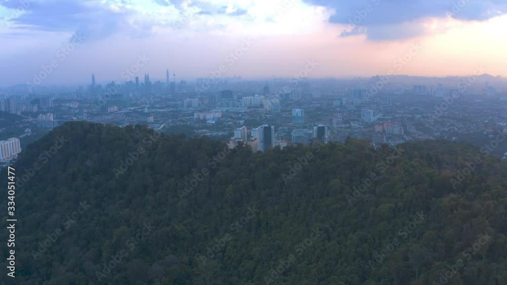 4k Scenic Aerial View of Bukit Tabur Quartz Ridge revealing dramatic sunset of Kuala Lumpur City Skyline. Establishing Shot 4k Scenic Aerial View of Bukit Tabur Quartz Ridge revealing dramatic sunset of Kuala Lumpur City Skyline. Establishing Shot