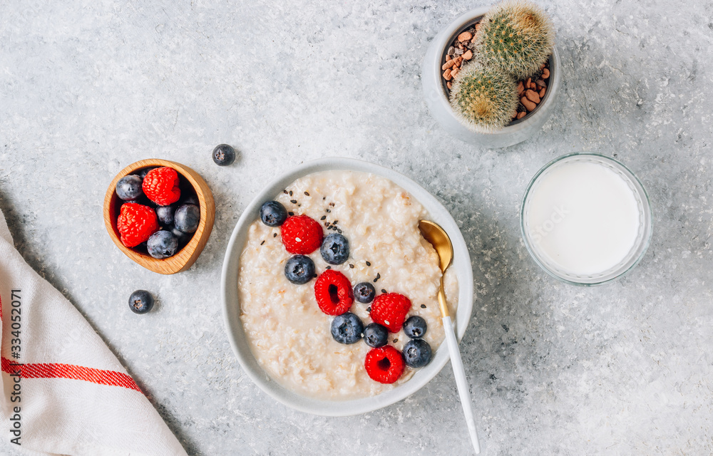 Breakfast oatmeal porridge with fresh berries and almond milk. Healthy vegan food concept. Top view. Copy space. Flat lay Breakfast oatmeal porridge with fresh berries and almond milk. Healthy vegan food concept. Top view. Copy space. Flat lay