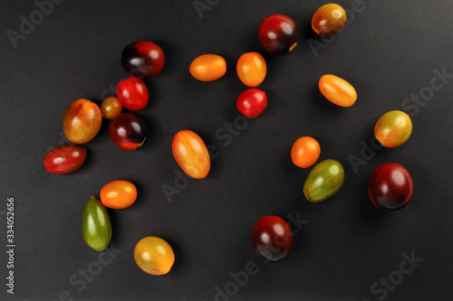 Fototapeta Naklejka Na Ścianę i Meble -  Fresh ripe mixed tomato verity assorted color on black background