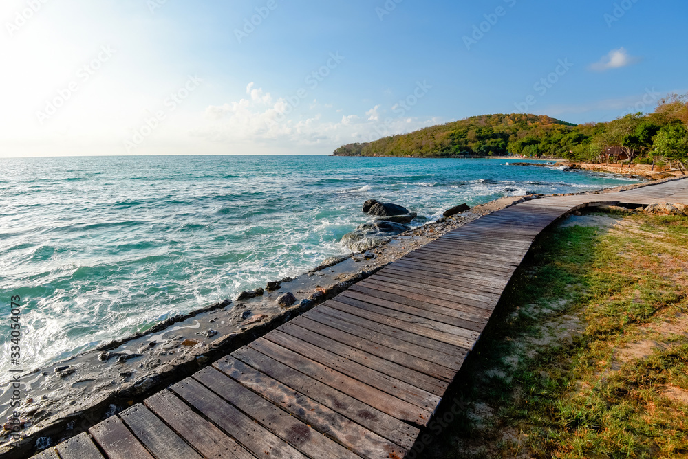 Wooden bridge balcony view seascape idyllic seashore silhouette tropical tree summer vacation beach - Terrace view sea with empty wooden table top on the beach landscape nature with sunlight sunrise