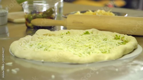 Close Up Detail of Uncooked Cheese and Pesto Pizza photo