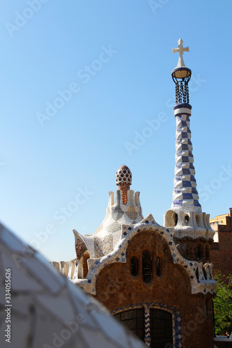 View of Gingerbread house in the Park Guell against blue clear sky in sunny day, Barcelona, Spain