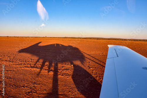 Silhouette of aircraft SR-22 in outback Australia red dirt summer