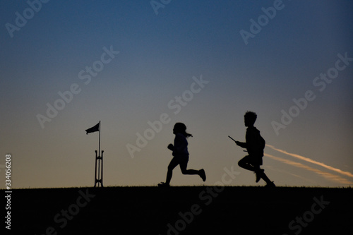 Silhouette of children running at sunset in Australia Parliament House